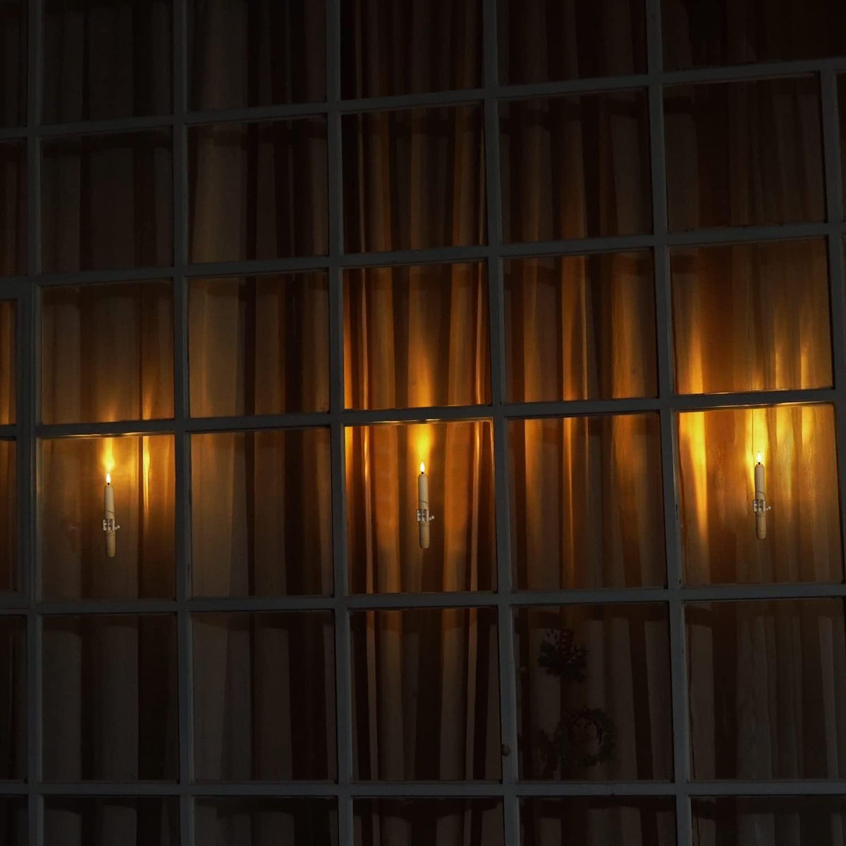 Dusk-to-dawn LED window candles with suction cups